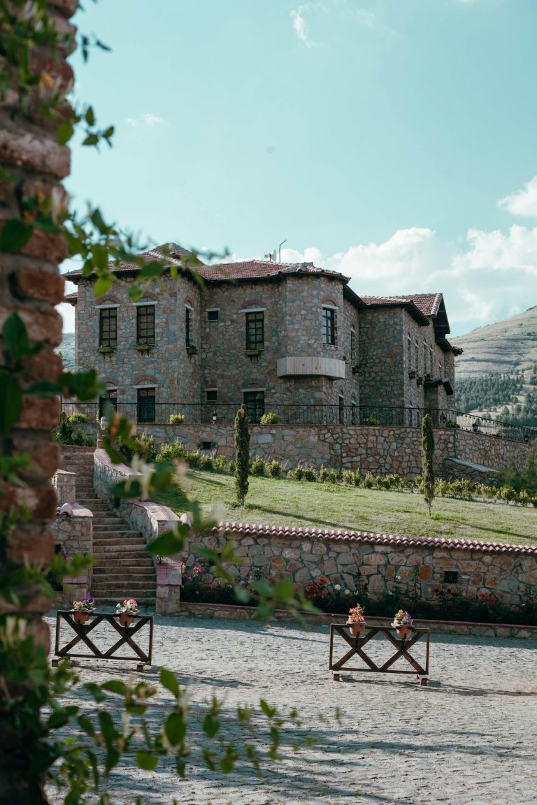 Rustic stone hotel with lush greenery in the village of Elazig, Turkey.